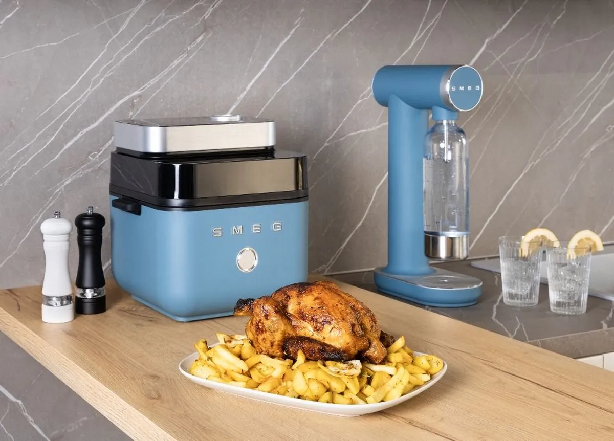 Air fryer Smeg AFC01 com tampa superior aberta e área translúcida com iluminação interna